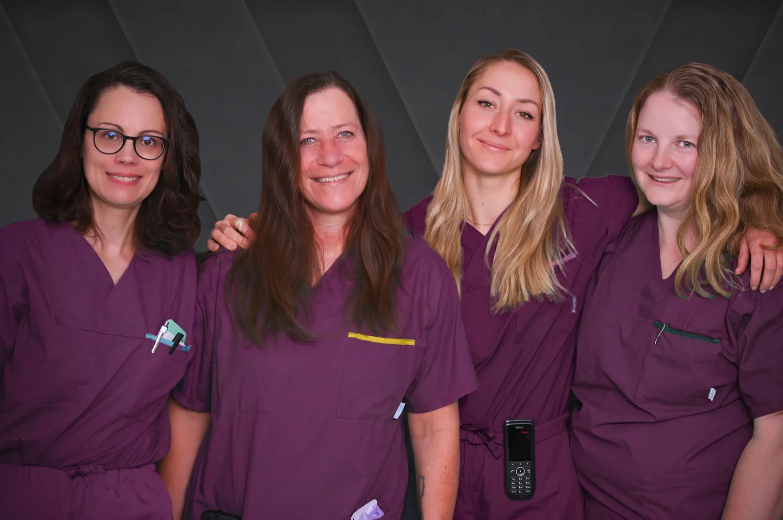 Four employees of the Bürgerspital Wertheim in purple uniforms
