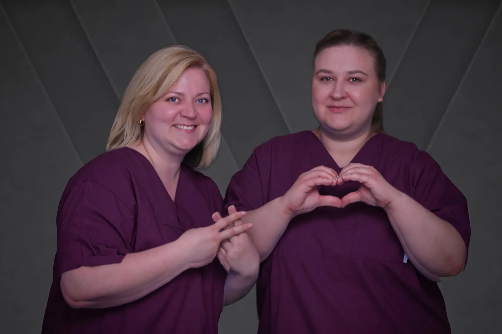Two employees of the Bürgerspital Wertheim form a heart with their hands